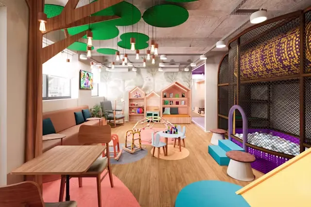 Área de espera infantil do consultório, com cantinho de brinquedos e decoração lúdica